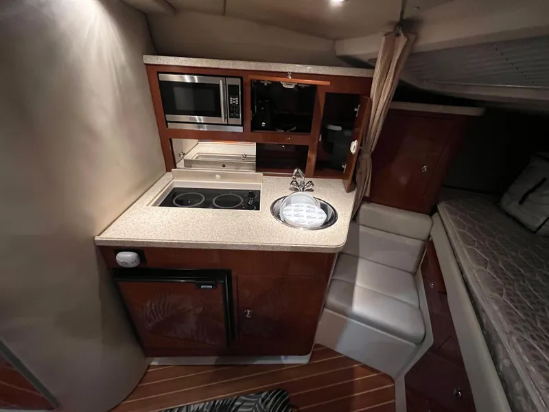 Slide: The Image of 2006 Regal 3360 Window Express interior with kitchenette and sleeping area. - 6