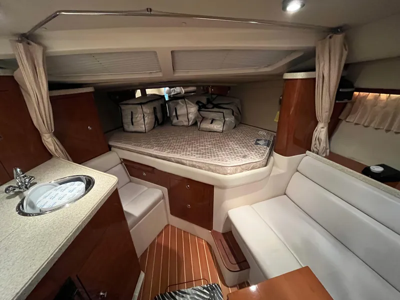 Slide: The Image of 2006 Regal 3360 Window Express cabin interior with seating, bed, and kitchenette. - 7