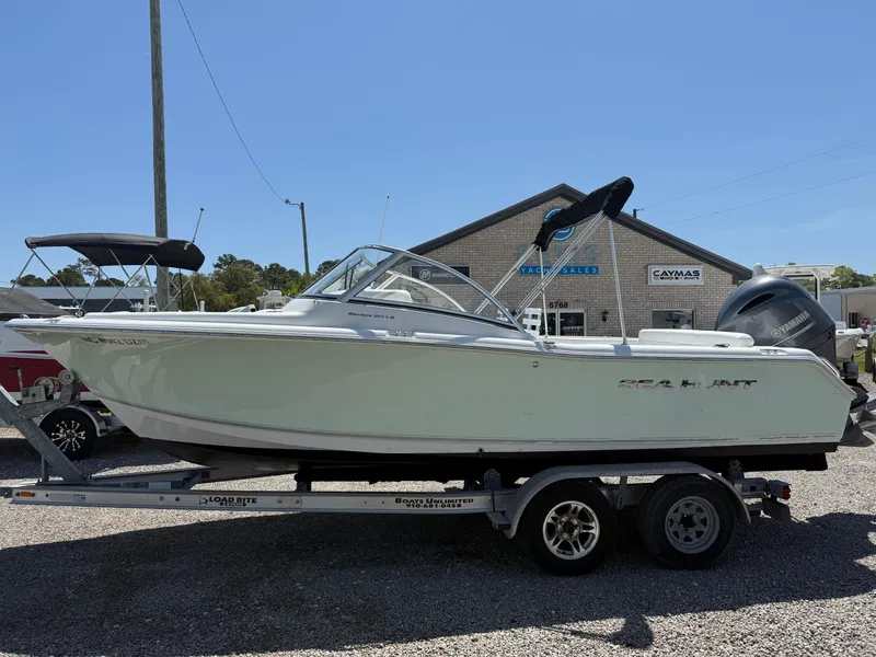 Slide: The Image of 2014 Sea Hunt Escape 211 LE boat on trailer, parked outdoors. - 1
