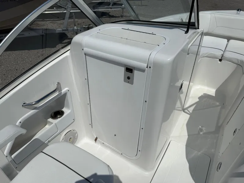 Slide: The Image of 2014 Sea Hunt Escape 211 LE boat interior with white seating and storage compartment. - 14