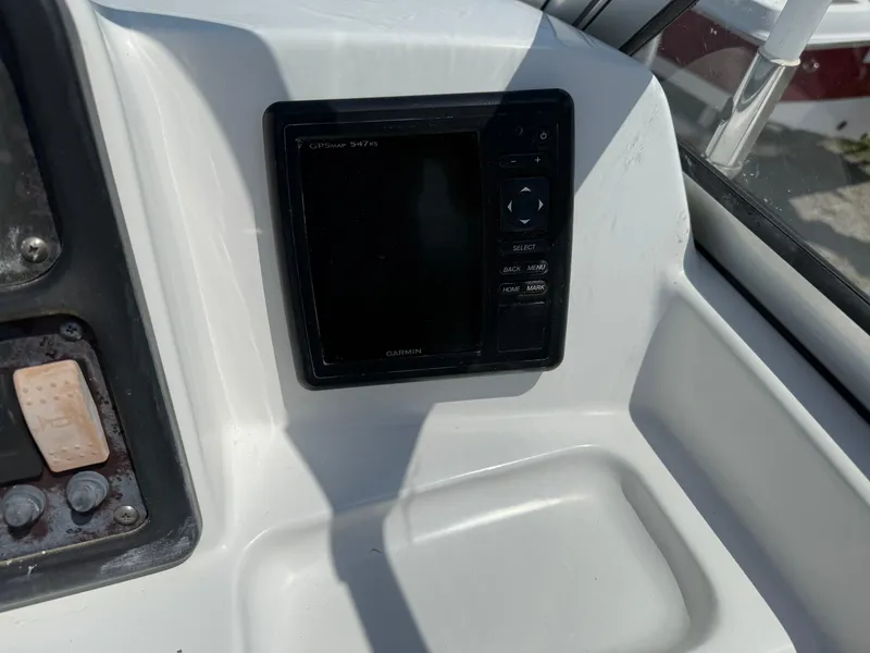 Slide: The Image of Control panel of a 2014 Sea Hunt Escape 211 LE boat, featuring navigation equipment. - 15
