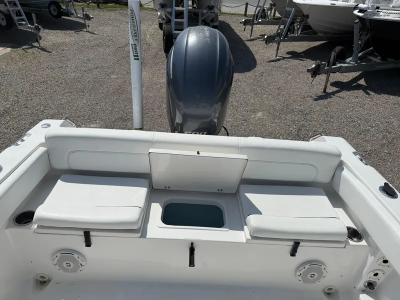 Slide: The Image of 2014 Sea Hunt Escape 211 LE boat interior with seating and motor view. - 17