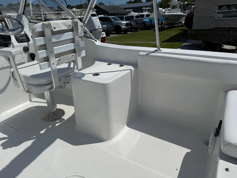 Slide: The Image of 2014 Sea Hunt Escape 211 LE boat interior with white seating and steering console. - 21