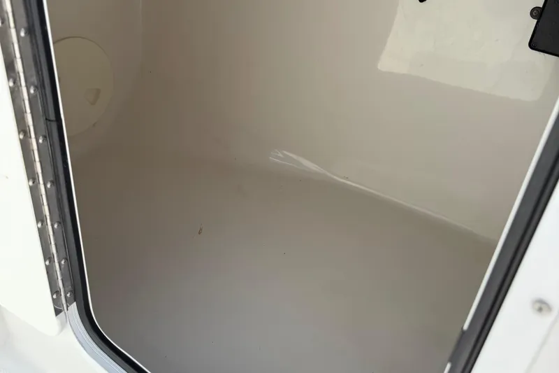 Slide: The Image of Storage compartment of 2014 Sea Hunt Escape 211 LE boat, showing clean interior space. - 22