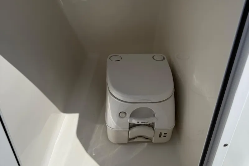 Slide: The Image of Portable toilet inside 2014 Sea Hunt Escape 211 LE boat compartment. - 23
