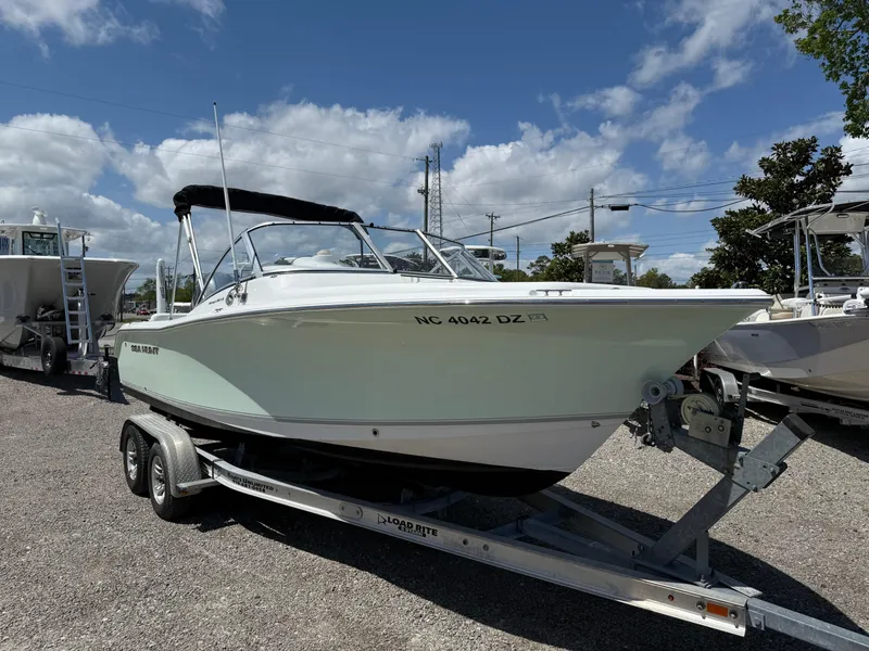 Slide: The Image of 2014 Sea Hunt Escape 211 LE boat on trailer under blue sky. - 7