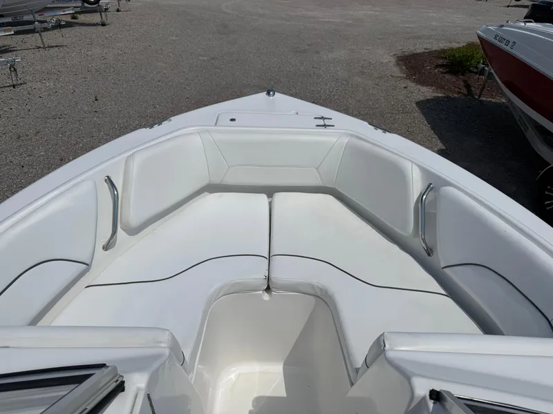 Slide: The Image of 2014 Sea Hunt Escape 211 LE boat interior with white cushioned seating. - 8