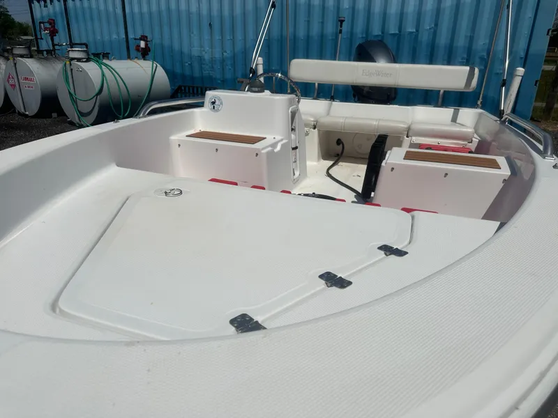 Slide: The Image of 2002 Edgewater 135ST boat interior with seating and storage compartments. - 12