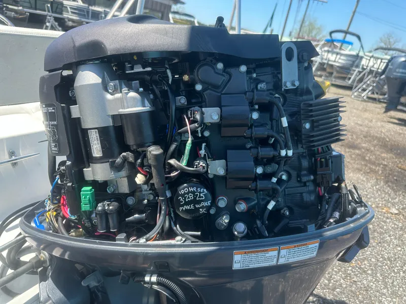 Slide: The Image of Close-up of a 2002 Edgewater 135ST boat engine, showcasing intricate mechanical components. - 18