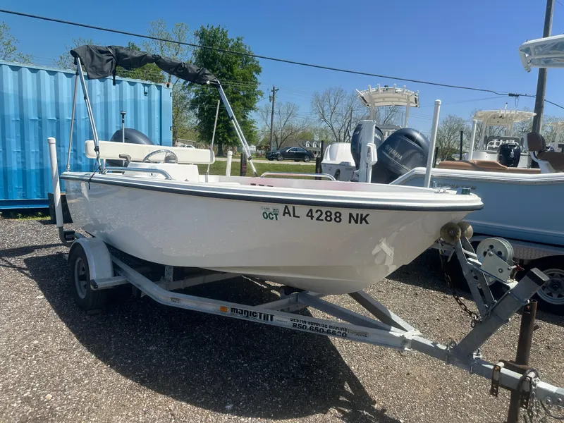 Slide: The Image of 2002 Edgewater 135ST boat on trailer, parked outdoors under clear blue sky. - 3