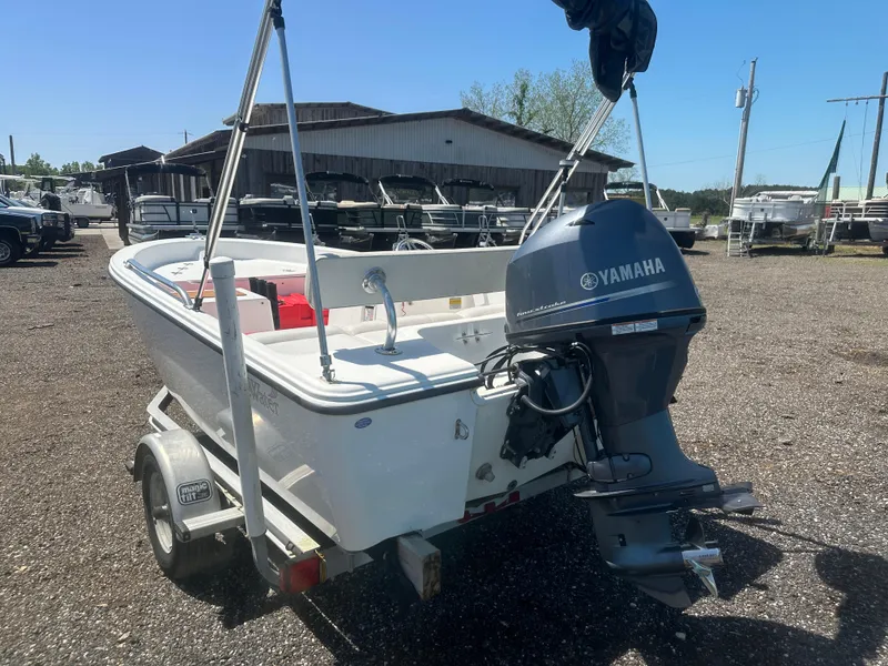 Slide: The Image of 2002 Edgewater 135ST boat with Yamaha outboard motor on a trailer, parked outdoors. - 7