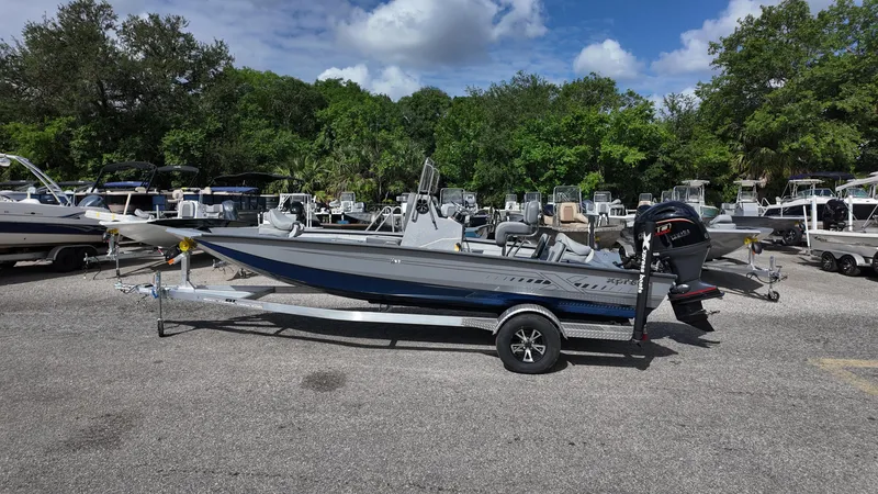 Slide: The Image of 2025 Xpress H20B boat on trailer in outdoor dealership lot. - 10