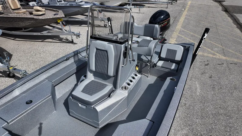 Slide: The Image of 2025 Xpress H20B boat with sleek design and modern seating, parked on pavement. - 22