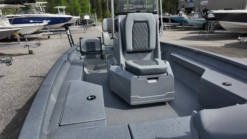 Slide: The Image of 2025 Xpress H20B boat interior with gray seating and storage compartments. - 25