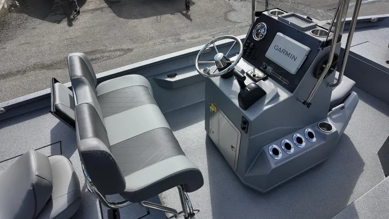 Slide: The Image of 2025 Xpress H20B boat interior with steering console and seating. - 27