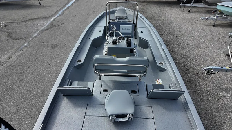 Slide: The Image of 2025 Xpress H20B boat with sleek design and modern console, parked on asphalt. - 30