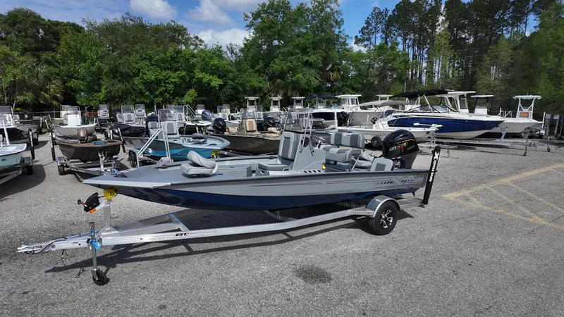 Slide: The Image of 2025 Xpress H20B boat on trailer in a marina parking lot. - 6
