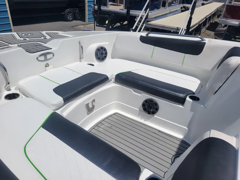 Slide: The Image of 2021 Tahoe 2150 boat interior with cushioned seating and speakers. - 10