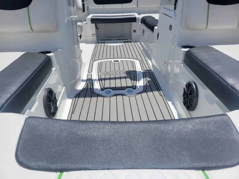 Slide: The Image of 2021 Tahoe 2150 boat interior with cushioned seating and sleek flooring design. - 13