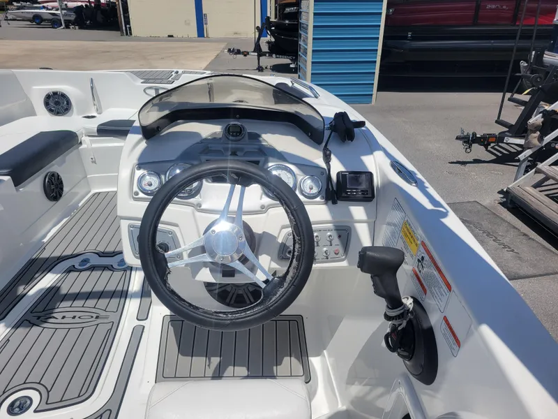 Slide: The Image of 2021 Tahoe 2150 boat cockpit with steering wheel and control panel. - 16