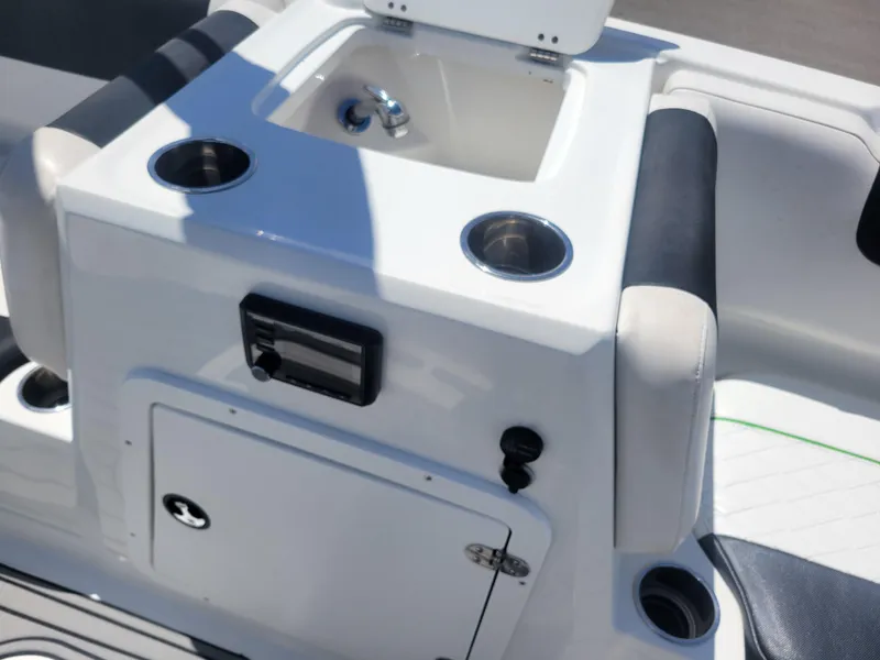Slide: The Image of 2021 Tahoe 2150 boat interior with sink and cup holders. - 20