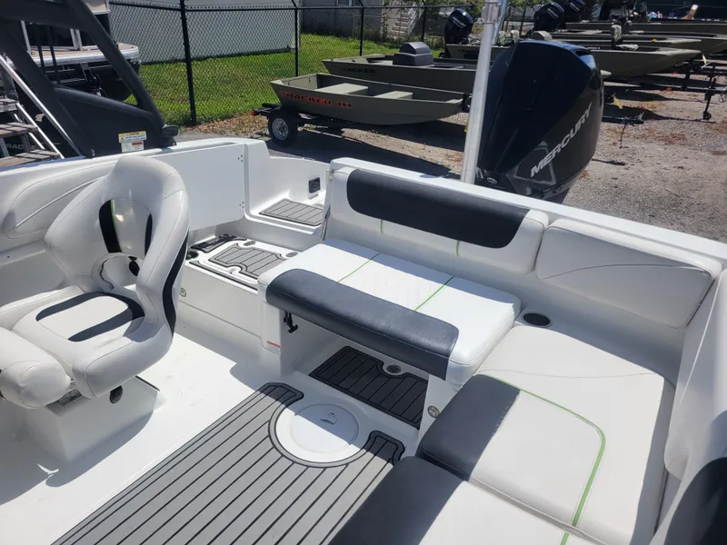 Slide: The Image of 2021 Tahoe 2150 boat interior with seating and Mercury outboard motor. - 8