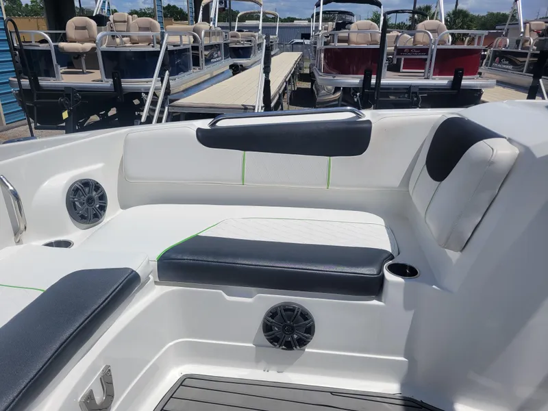 Slide: The Image of 2021 Tahoe 2150 boat interior with seating, speakers, and cup holders. - 9