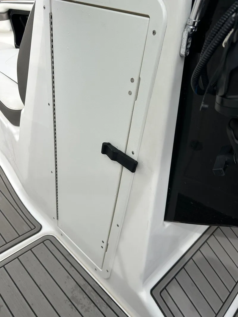Slide: The Image of 2015 Yamaha Boats 242 Limited S interior storage compartment with sleek design and secure latch. - 12