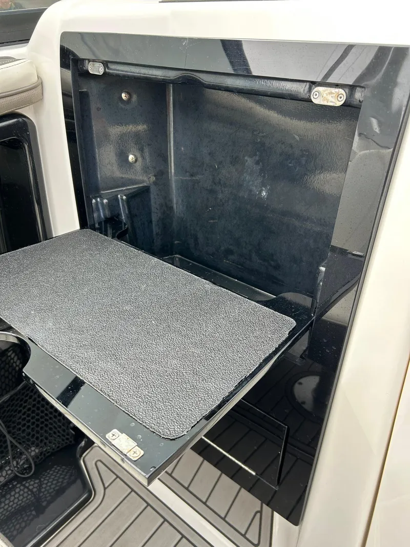Slide: The Image of Yamaha Boats 2015 242 Limited S storage compartment with open hatch and textured surface. - 15