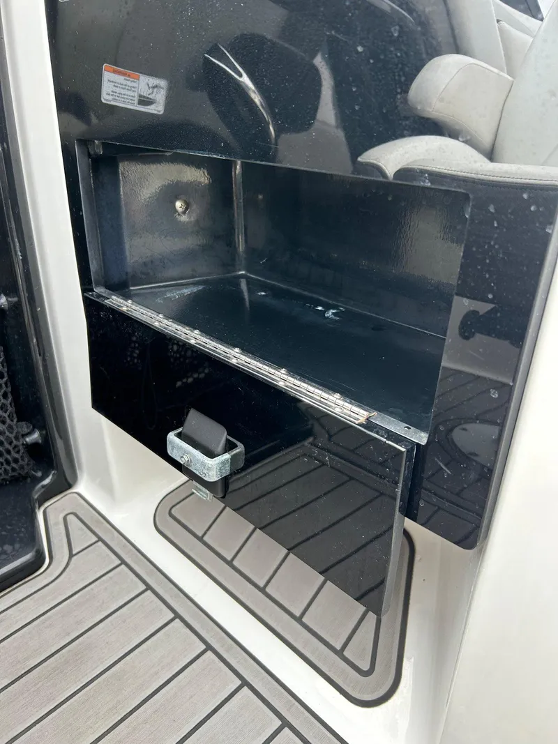 Slide: The Image of 2015 Yamaha Boats 242 Limited S storage compartment with sleek black interior. - 16
