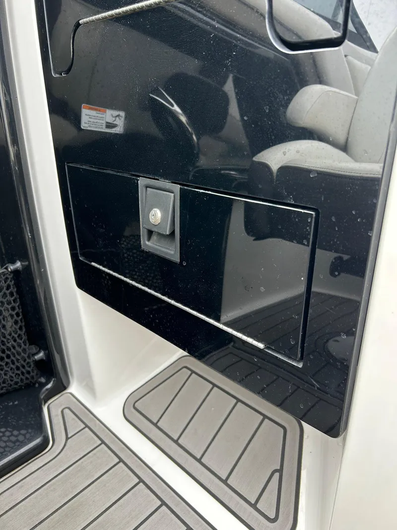 Slide: The Image of 2015 Yamaha Boats 242 Limited S interior detail with storage compartment and seating. - 17