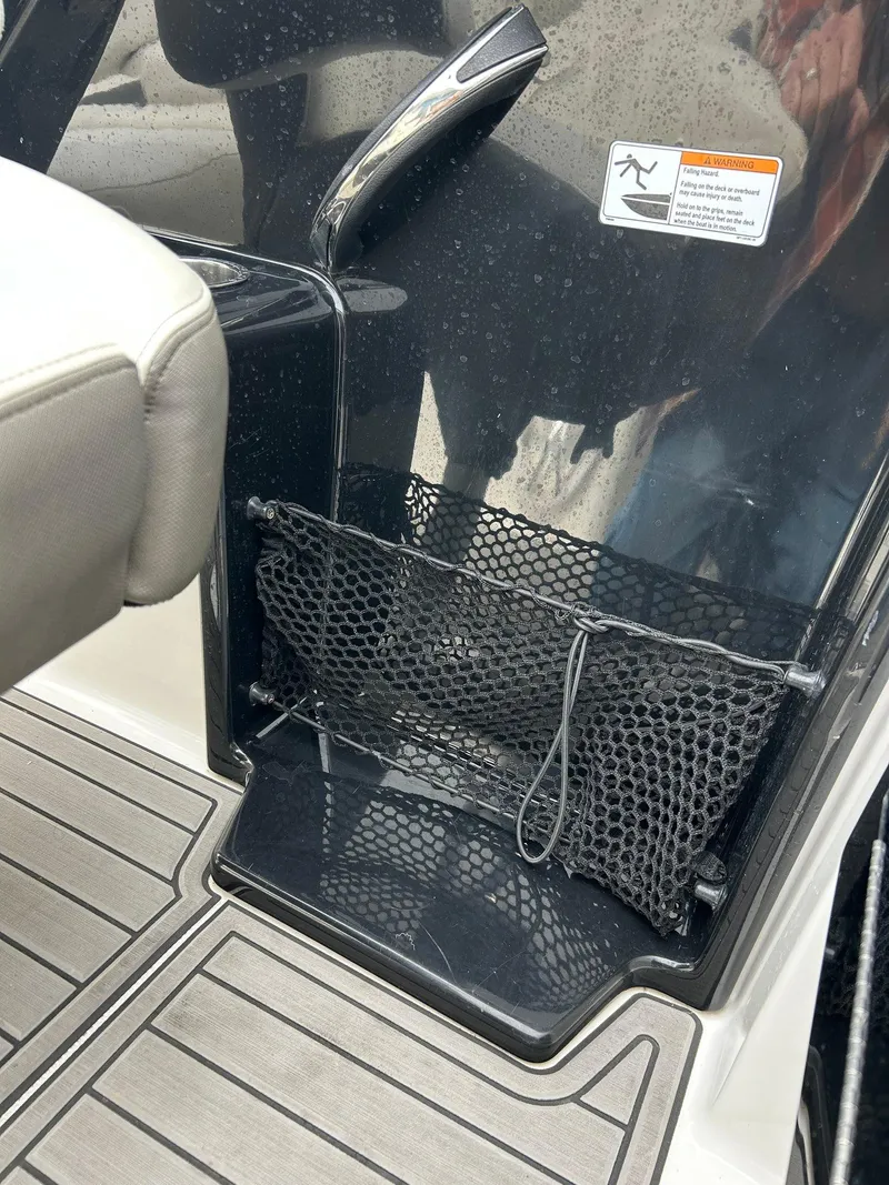 Slide: The Image of 2015 Yamaha Boats 242 Limited S interior with net storage and sleek design. - 18