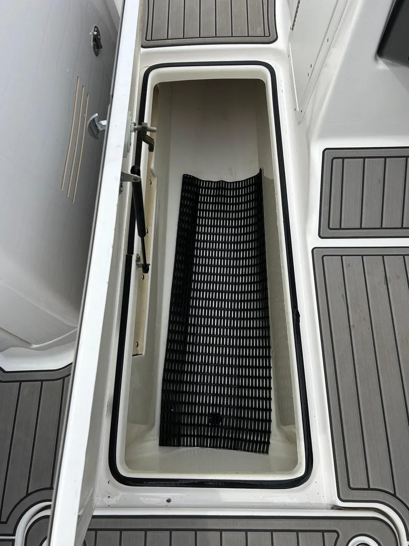 Slide: The Image of 2015 Yamaha Boats 242 Limited S storage compartment with non-slip mat. - 27
