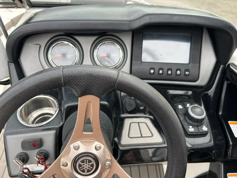 Slide: The Image of Steering console of a 2015 Yamaha Boats 242 Limited S with gauges and controls. - 3