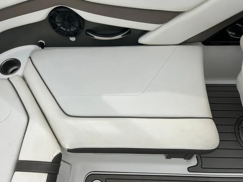 Slide: The Image of 2015 Yamaha Boats 242 Limited S interior seating with speaker and cup holder. - 31