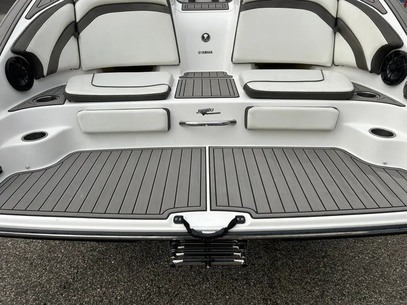 Slide: The Image of 2015 Yamaha Boats 242 Limited S swim platform with cushioned seating and sleek design. - 36