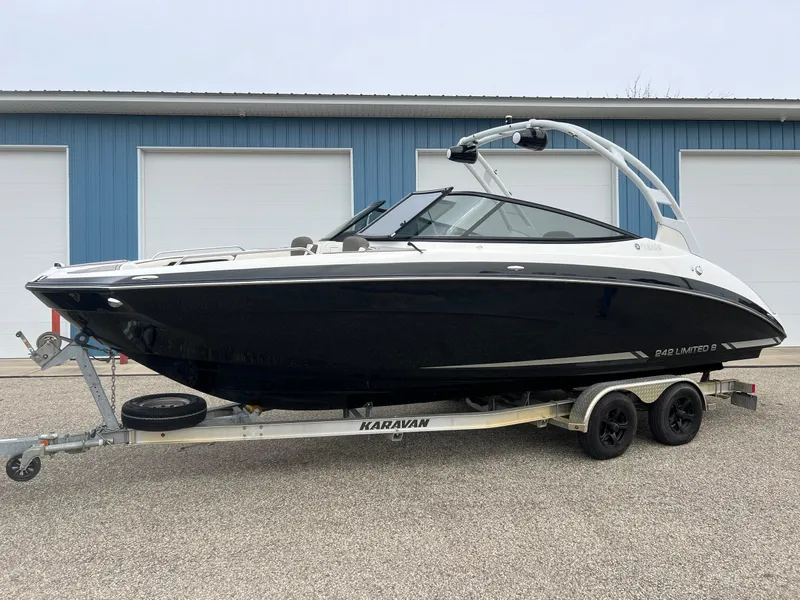 Slide: The Image of 2015 Yamaha Boats 242 Limited S on trailer, parked near blue garage doors. - 38