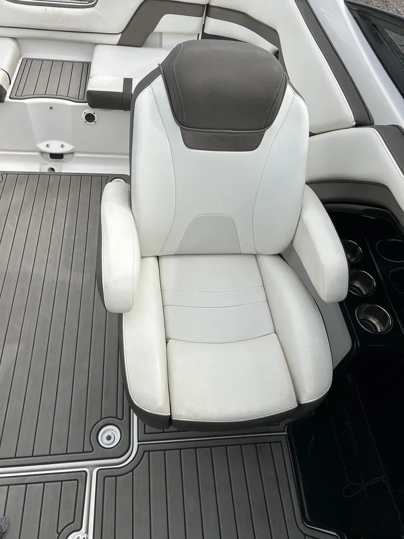 Slide: The Image of 2015 Yamaha Boats 242 Limited S seat with gray and white upholstery, cup holders visible. - 7