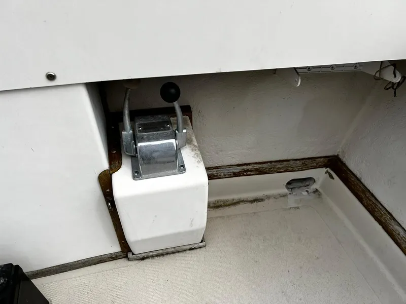 Slide: The Image of Control lever on a 1983 Fortier 26 boat, mounted on a white panel. - 11