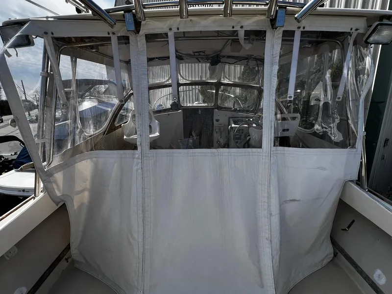 Slide: The Image of 1983 Fortier 26 boat with enclosed cockpit and clear vinyl windows. - 12