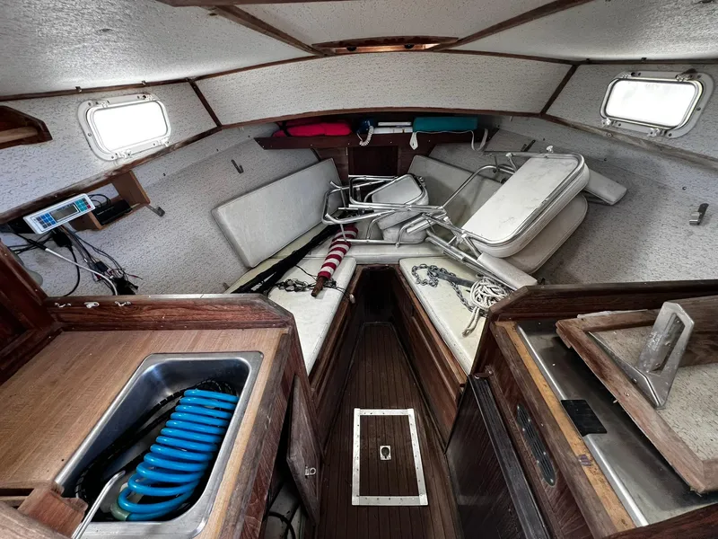 Slide: The Image of Interior of 1983 Fortier 26 boat with wooden finishes and compact cabin layout. - 24