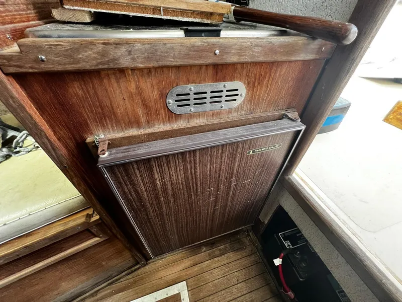 Slide: The Image of 1983 Fortier 26 boat interior with wooden cabinetry and vintage design elements. - 26