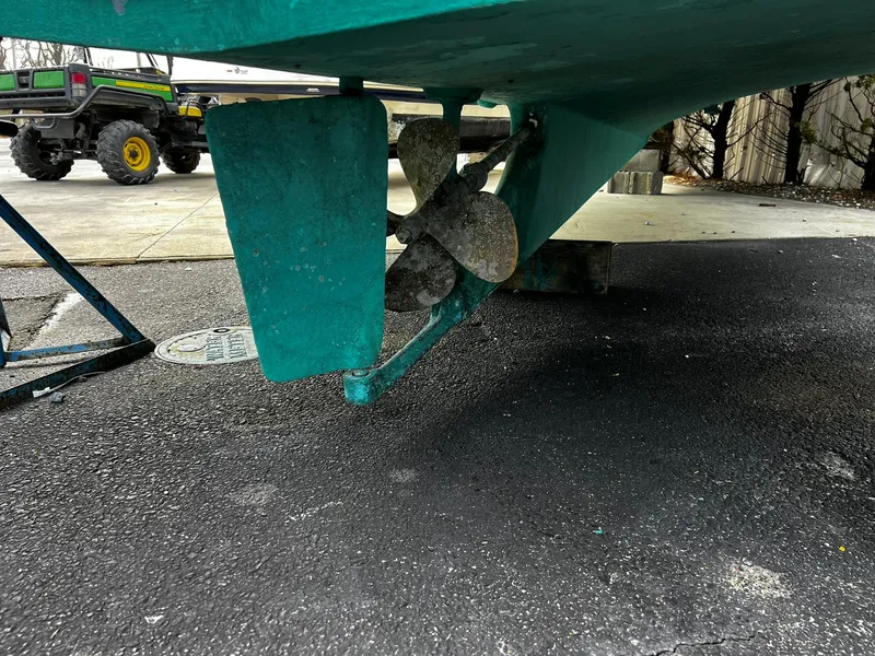 Slide: The Image of Propeller and rudder of 1983 Fortier 26 boat on pavement. - 30