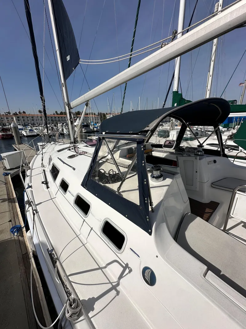 Slide: The Image of 2008 Hunter 38 sailboat docked at marina, featuring sleek design and spacious deck. - 12