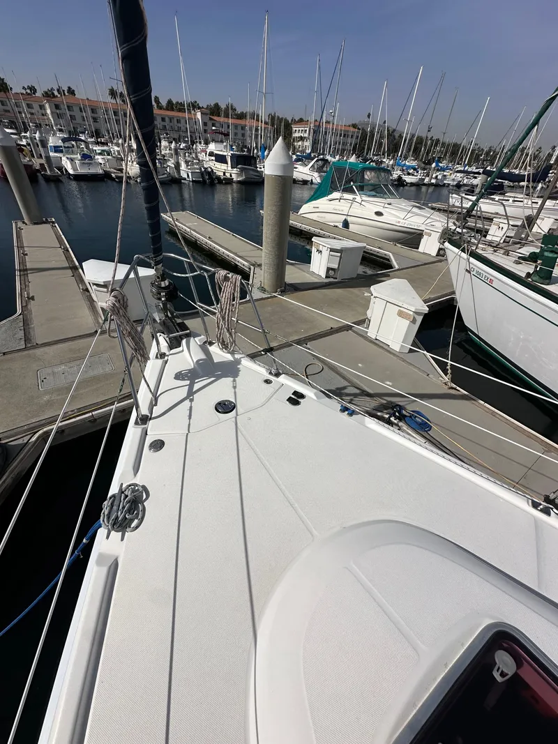 Slide: The Image of 2008 Hunter 38 sailboat docked at a marina with other boats. - 14