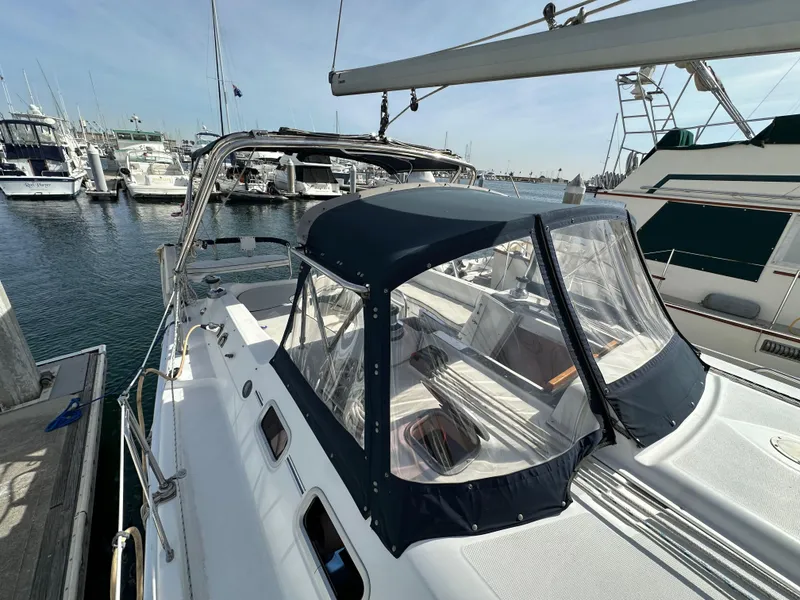 Slide: The Image of 2008 Hunter 38 sailboat docked at marina with protective canopy. - 18
