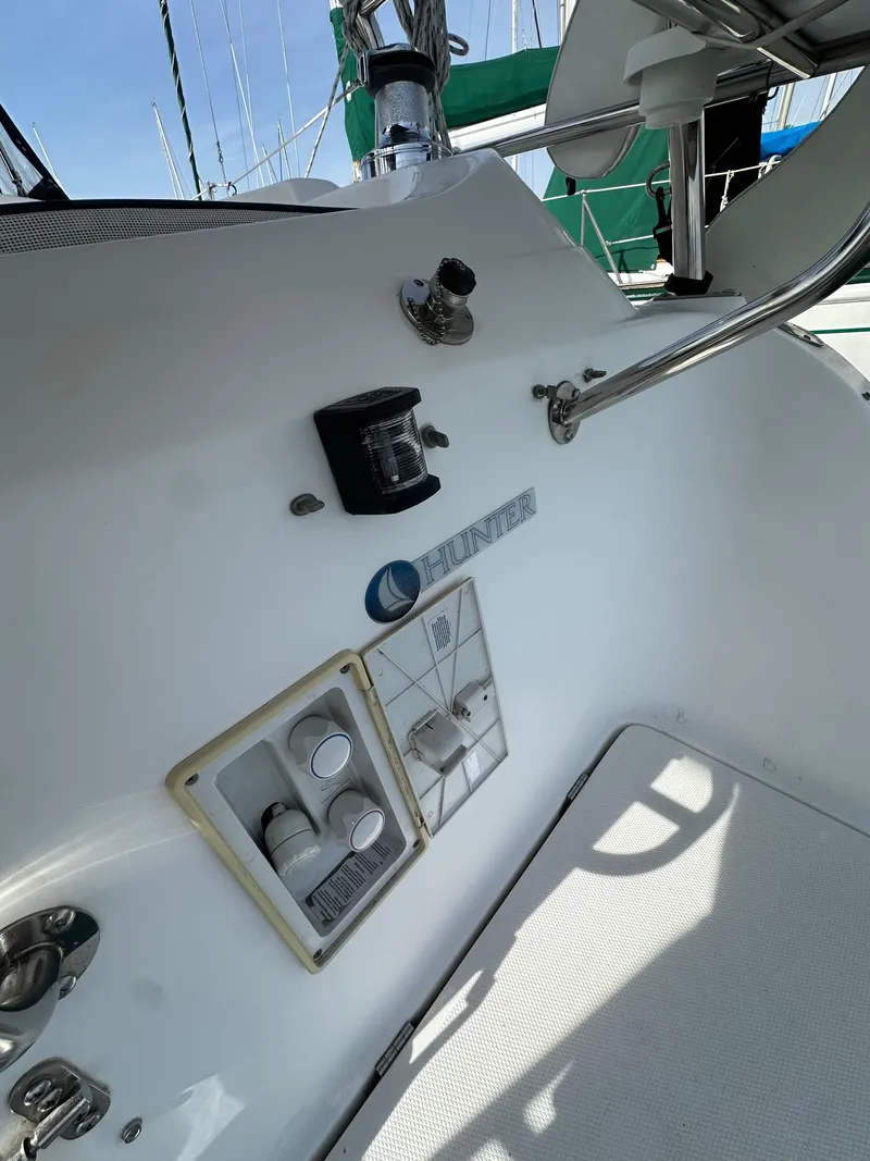 Slide: The Image of 2008 Hunter 38 sailboat cockpit with control panel and steering wheel. - 23