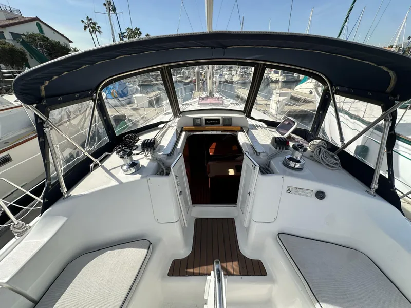 Slide: The Image of 2008 Hunter 38 sailboat cockpit with canopy, featuring seating and navigation equipment. - 34