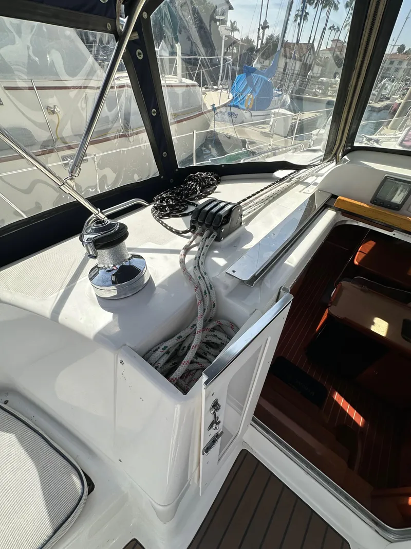 Slide: The Image of 2008 Hunter 38 sailboat cockpit with winch, ropes, and navigation equipment. - 36