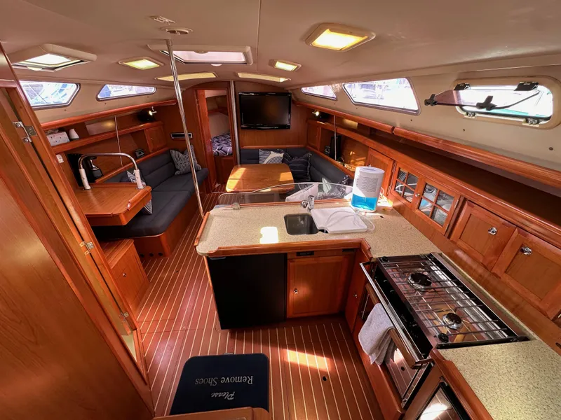 Slide: The Image of Interior of 2008 Hunter 38 sailboat with wood finish, kitchen, and seating area. - 39